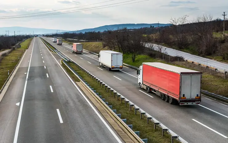 Trucks on the highway depicting the transportation of goods.